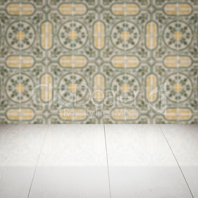 Wood table top and blur vintage ceramic tile pattern wall