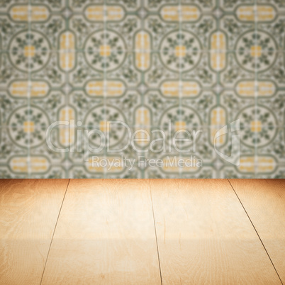 Wood table top and blur vintage ceramic tile pattern wall