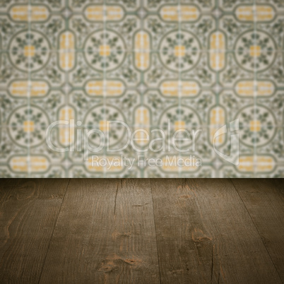 Wood table top and blur vintage ceramic tile pattern wall