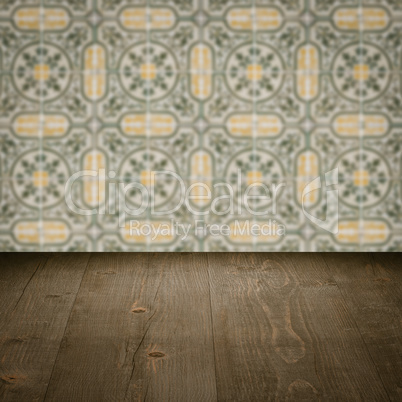 Wood table top and blur vintage ceramic tile pattern wall