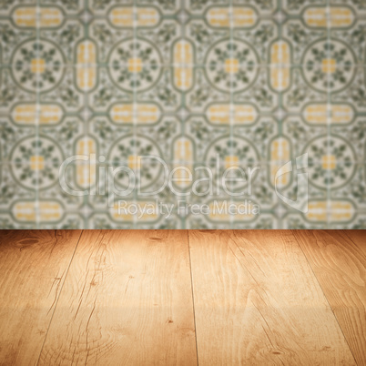 Wood table top and blur vintage ceramic tile pattern wall Wood table top and blur vintage ceramic tile pattern wall