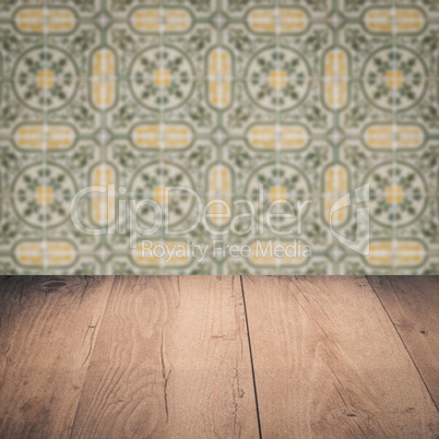 Wood table top and blur vintage ceramic tile pattern wall