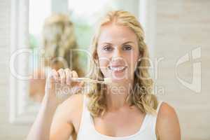 Beautiful woman brushing her teeth