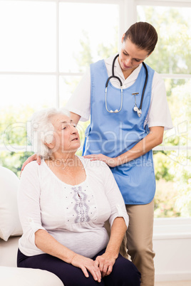 Nurse taking care of sick elderly woman