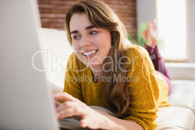 Smiling pretty woman using laptop