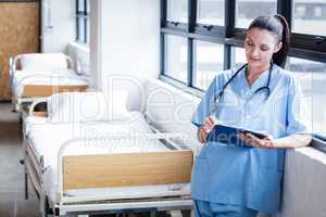 Nurse writing on a clipboard