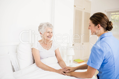 Nurse taking care of suffering senior patient