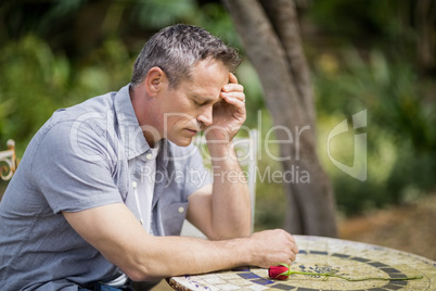 Depressed man touching his forehead