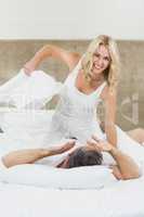 Cute couple playing pillow fight