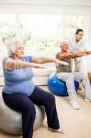 Physiotherapist helping patients with exercises