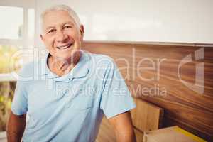 Senior man standing and looking at the camera