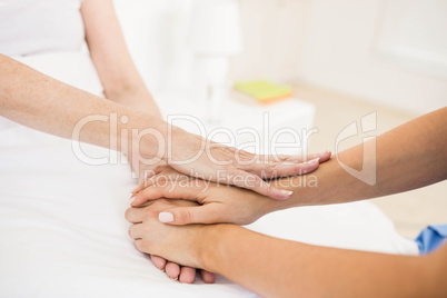 Nurse taking care of suffering senior patient