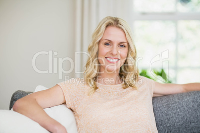 Pretty woman sitting on her couch