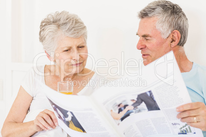 Senior couple reading newspaper