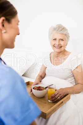 Nurse taking care of suffering senior patient