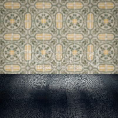 Wood table top and blur vintage ceramic tile pattern wall Wood table top and blur vintage ceramic tile pattern wall