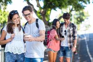 Hip couples checking at smartphone