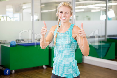 Smiling woman showing thumbs up