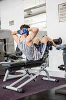 Man doing abdominal crunches on bench