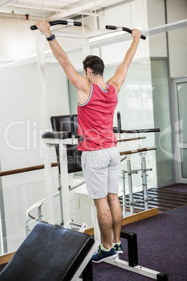 Muscular man doing pull up