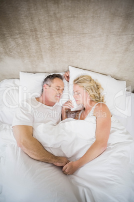 Cute couple sleeping in their bed