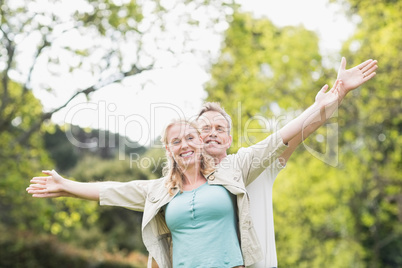 Cute couple raising arms