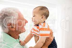 Senior man playing with his grandson