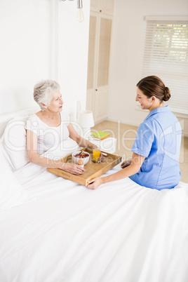 Nurse taking care of suffering senior patient