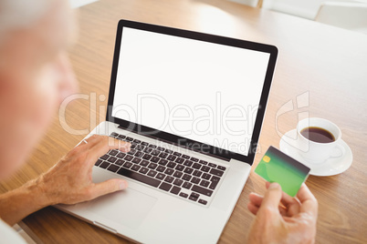 Elderly man spending money on internet