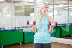 Fit woman lifting dumbbells