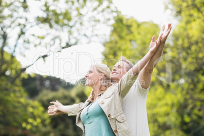 Cute couple raising arms