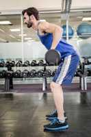 Muscular man lifting barbell