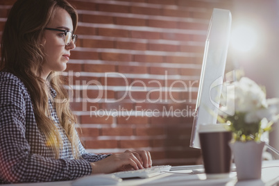 Focused hipster businesswoman watching computer