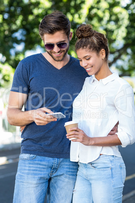 Hip couple looking at smartphone