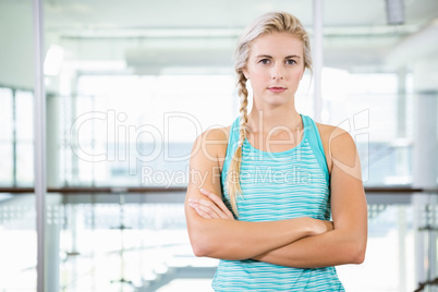 Serious blonde standing with arms crossed