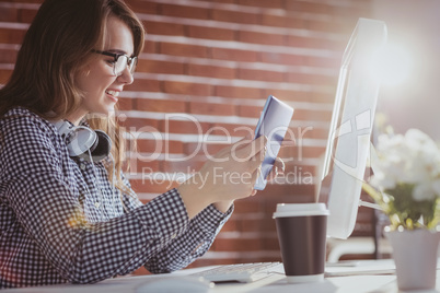 Smiling hipster businessman using tablet