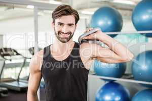 Concentrated man lifting kettlebell