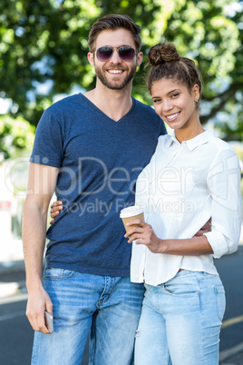 Hip couple smiling at the camera