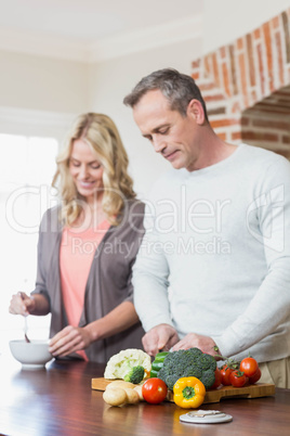 Cute couple slicing vegetables