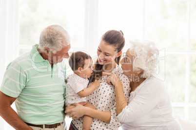 Happy grandparents playing with their grandson