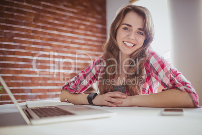 Smiling hipster businesswoman looking at the camera