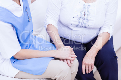 Nurse taking care of sick elderly woman