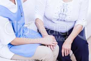 Nurse taking care of sick elderly woman