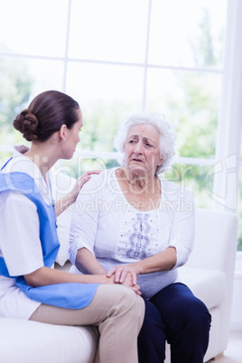 Nurse taking care of sick elderly woman