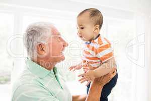 Senior man playing with his grandson