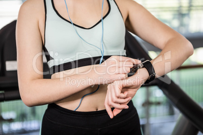 Mid section of woman using smartwatch
