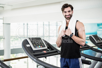 Smiling man standing on treadmill Smiling man standing on treadmill