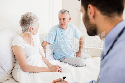 Handsome nurse visiting a mature woman