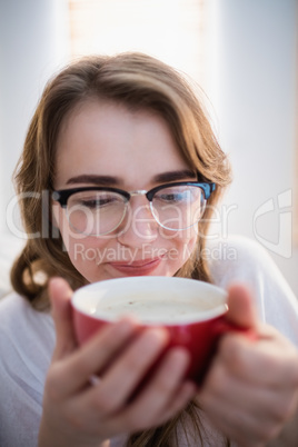 Pretty woman relaxing on couch with coffee