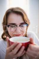 Pretty woman relaxing on couch with coffee